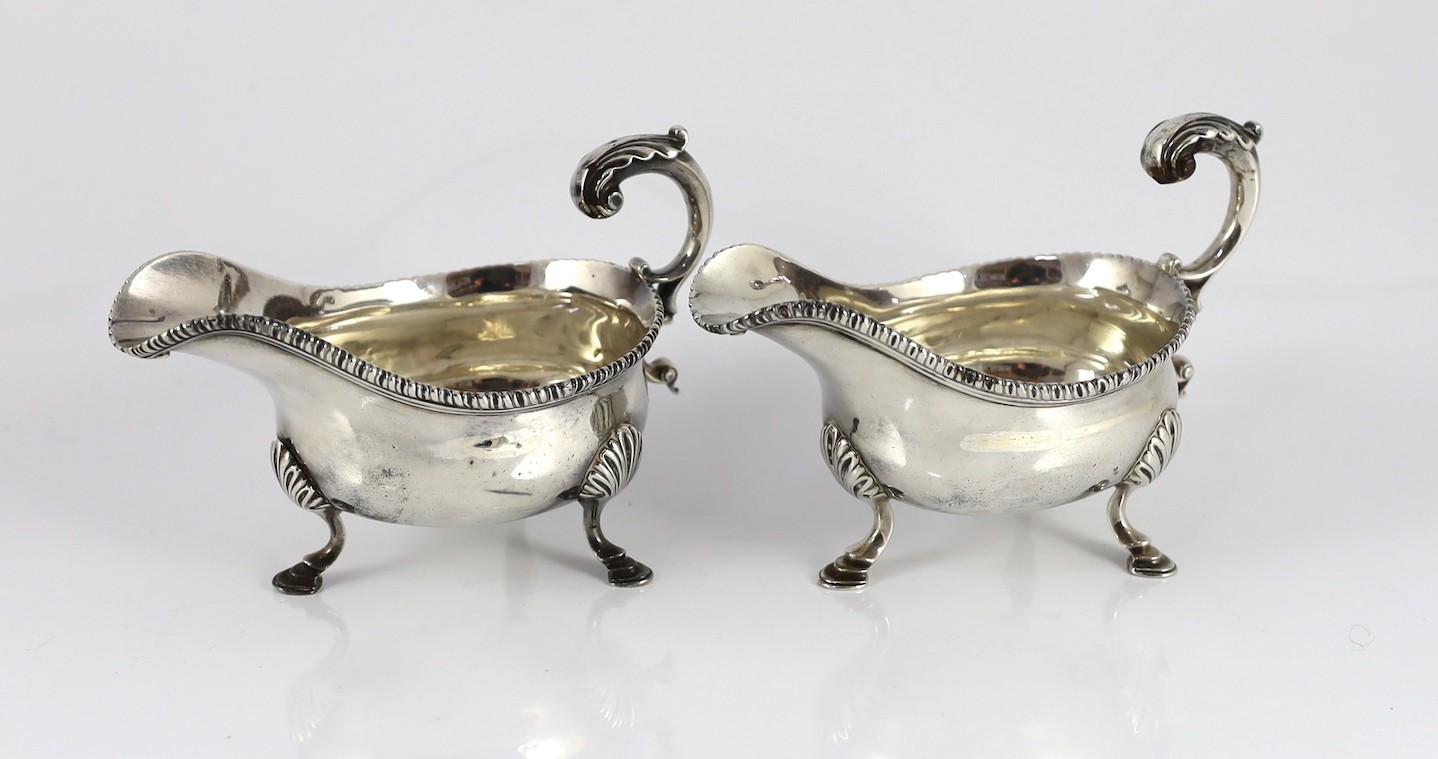 A near pair of George III silver sauceboats